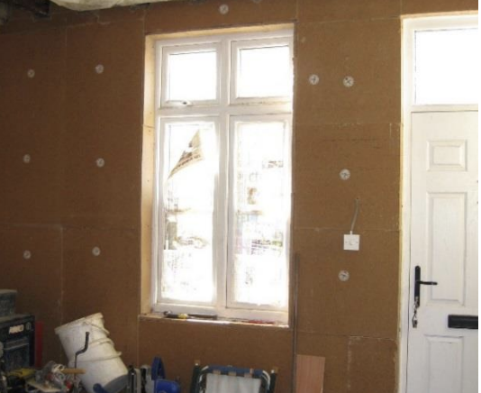 Wood fibre boards 80mm thick fixed direct to wall with concrete screws and plastic washers, uvalue 0.36 W/m2K