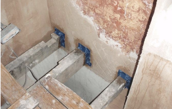 After plastering, joist ends were taped to plaster, with a second skim coat over the tapes