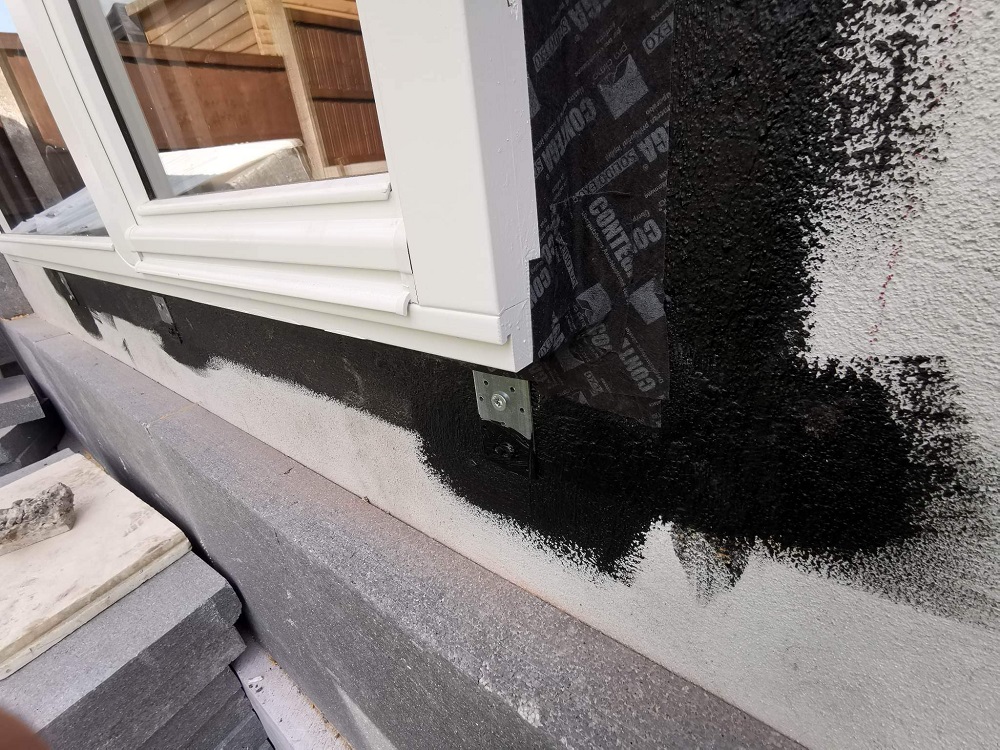 Brackets holding window within external wall insulation layer, AECB Retrofit Standard bungalow, Wrexham